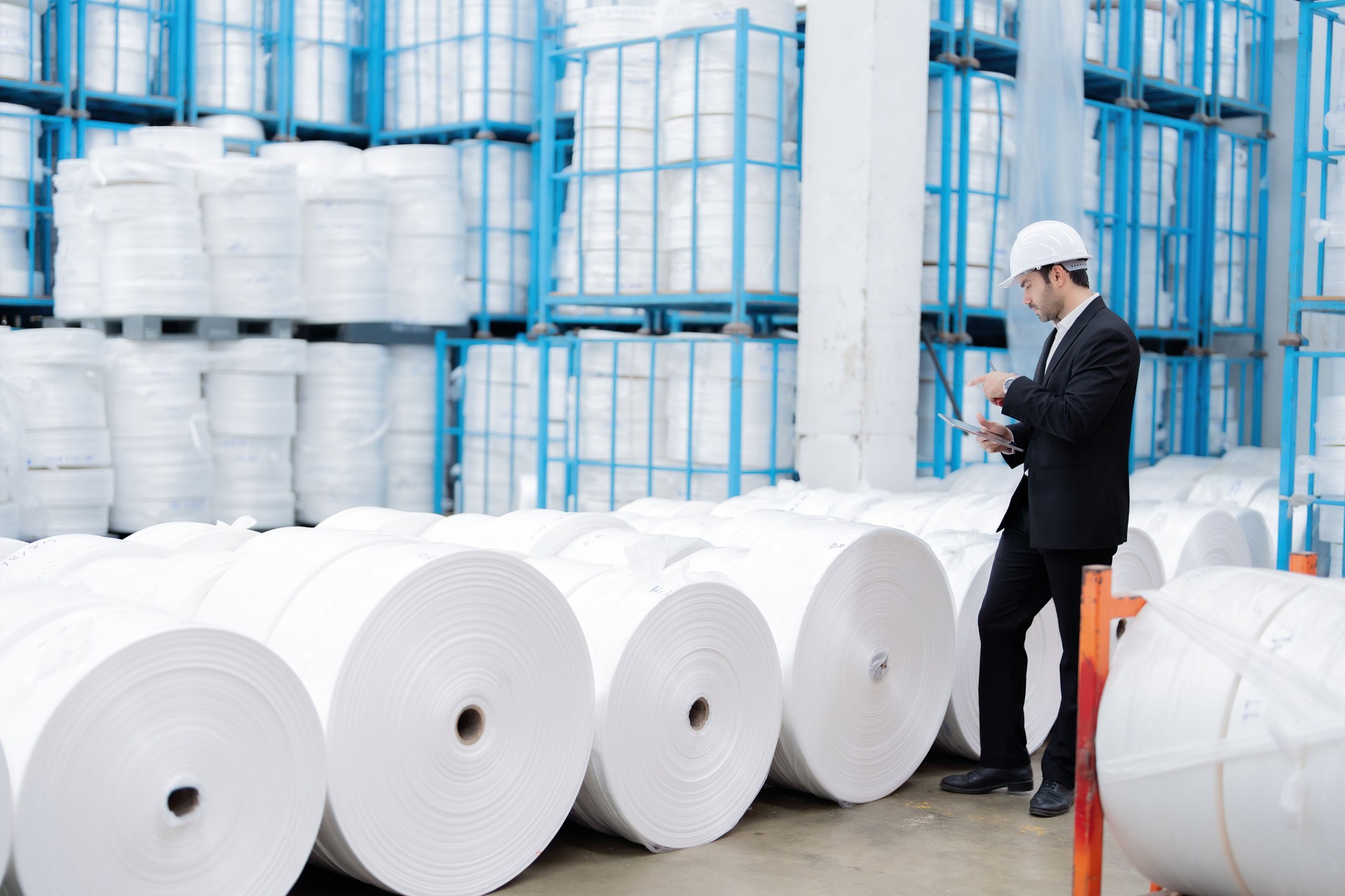 After identifying stress fractures, the male engineer improved the industrial plant's machinery design to prevent breakdowns while working with tough plastic and steel.